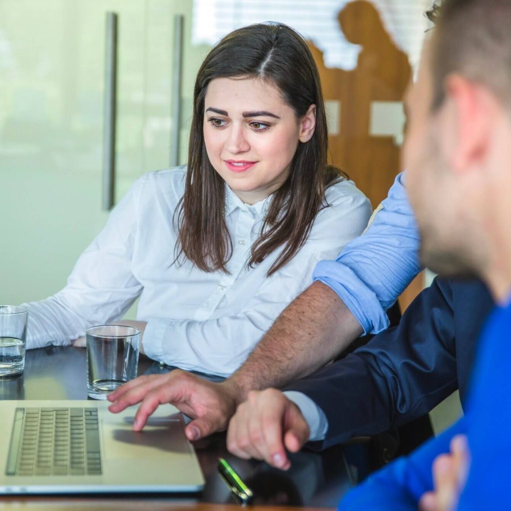 woman reading laptop in business office looking for RPZ valve services in Yorkshire